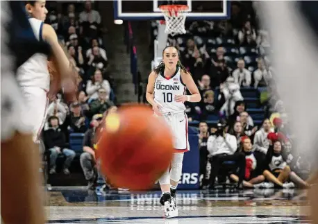  ?? Jessica Hill/Associated Press ?? UConn’s Nika Muhl runs backward after breaking UConn’s single-season assist record held previously by Sue Bird in the first half against Xavier on Monday in Storrs.