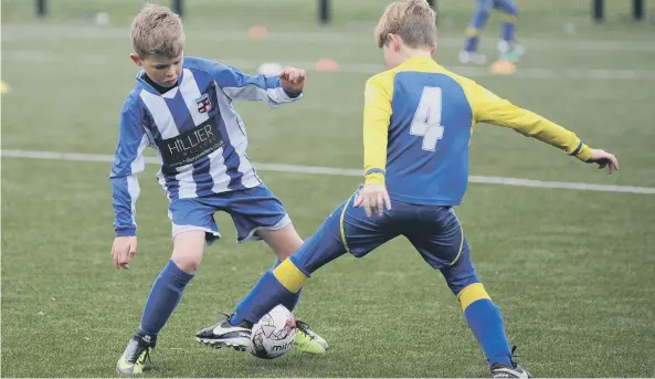  ??  ?? Russell Foster Mini Soccer Under-9s Winter League action between Hetton Juniors Roma (yellow) and Seaton United Tigers, played at Castle View Enterprise Academy, Sunderland.