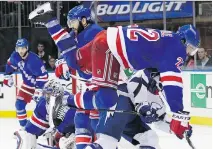  ?? FRANK FRANKLIN/THE ASSOCIATED PRESS ?? New York Rangers defenceman Dan Boyle collides with Tampa Bay Lightning right winger Ryan Callahan during the third period of Game 5 on Sunday. The Lightning won 2-0.