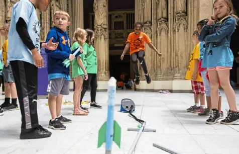  ?? Pittsburgh Post-Gazette photos ?? Zahniya Williams, 10, of Montour Elementary School, jumps on a pump to launch her paper rocket at the Carnegie Museum of Art during a kickoff event for Remake Learning Days in May 2019.