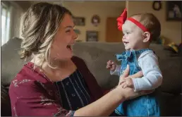  ?? BEA AHBECK/NEWS-SENTINEL ?? Brittani Jernigan holds her daughter, Blakely Jernigan, 9 months, at her Lodi home Wednesday.