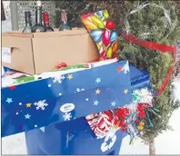 ?? CP PHOTO ?? A blue recycling bin is shown with Christmas wrapping paper, bottles, along with other items that get thrown out after Christmas in Gatineau, Que. Canadians will send more than 540,000 tonnes of wrapping paper and gift bags to the garbage dump this...