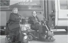  ??  ?? Marie Murphy and Martin Anderson in front of a Via Rail train at Toronto’s Union Station.