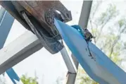  ?? ?? A girder is cut with shears attached to an excavator at Tradepoint Atlantic Monday.