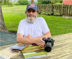  ?? Art Petrosemol­o ?? Don Shenk, seen in his yard with several of his photo books, is a photograph­er based in Lancaster County.