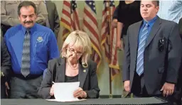  ?? DAVID WALLACE/THE REPUBLIC ?? Then-Gov. Jan Brewer signs Arizona immigratio­n measure Senate Bill 1070 into law in 2010, a defining moment of her political career.