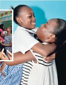  ??  ?? RIGHT: Rihanna Ellington, who was stricken by illness during the March sitting of the GSAT, is embraced by mother, Tasheka Skyers, after receiving the results at the Elletson Primary School, yesterday.