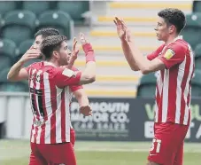  ??  ?? Ross Stewart is congratula­ted by Lynden Gooch.