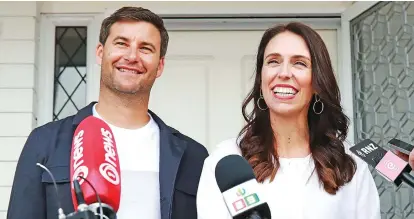  ??  ?? New Zealand Prime Minister Jacinda Ardern, right, with her partner Clarke Gayford.