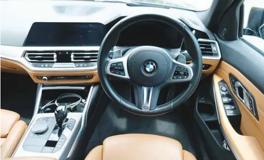  ?? ?? The interior of the G20 BMW 3-Series has been criticised for being too mellow. The overall layout is still the same in the M340i. The brown leather and aluminium trimming gives it a classy yet sporty ambiance.