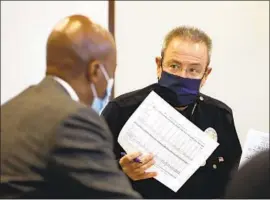  ?? Al Seib Los Angeles Times ?? CHIEF MICHEL MOORE, right, talks with Los Angeles Police Commission­er Dale Bonner on Monday during a weekly crime briefing at LAPD headquarte­rs.