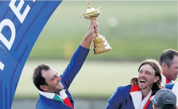  ?? ALASTAIR GRANT / THE ASSOCIATED PRESS ?? Europe’s Francesco Molinari holds up the Ryder Cup following his team’s decisive win in France Sunday.
