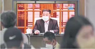  ?? ?? BEHIND THE VEIL: People in Seoul watch North Korea’s leader Kim Jong Un appear in a face mask on television on Thursday for the first time as he orders nationwide lockdowns.