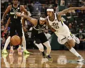  ?? JEFFREY PHELPS — THE ASSOCIATED PRESS ?? Milwaukee Bucks guard Justin Robinson (55) and Utah Jazz guard Jordan Clarkson (00) reach for the ball during the second half Sunday in Milwaukee.