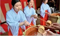  ?? AFP ?? People receive Japanese sake to celebrate the change of an era at Meiji Shrine in Tokyo. —