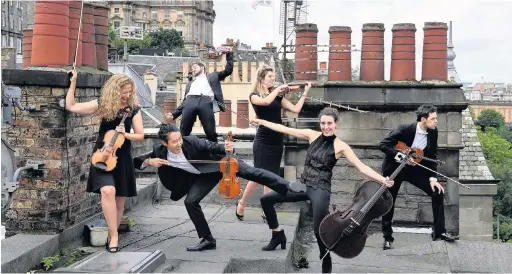  ??  ?? > Members of the Catalonian string orchestra Orquestra de Cambra d’Emporda in Edinburgh yesterday. Performing at the Assembly Rooms at this years Edinburgh Festival Fringe, the musicians take on movie soundtrack­s and pop songs, as well as classical...