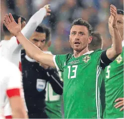  ?? Picture: PA. ?? Corry Evans reacts to the award of the penalty which gave Switzerlan­d a one-goal lead for the second leg.