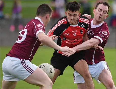  ??  ?? Dylan Maher (St Kevin’s) is caught in an O’Connell’s sandwich as Robert Quigley and Dean Stanfield try to dispossess him in Dunleer on Saturday evening.