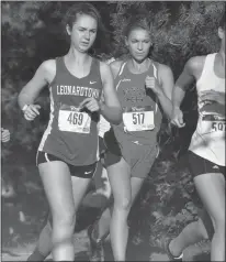  ?? STAFF PHOTO BY MICHAEL REID ?? North Point’s Mya Rivenburg, right, and Courteney Lawson of Leonardtow­n run side-by-side during the girls race Wednesday that also included La Plata and Northern.