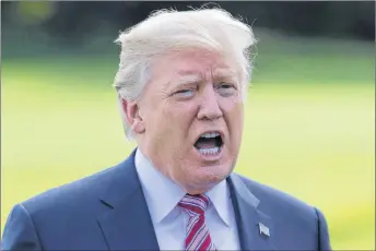  ?? AP PHOTO ?? President Donald Trump talks to media as he walks across the south lawn of the White House in Washington. Trump is lashing out at the mayor of Puerto Rico’s capital city in a war of words over recovery efforts after hurricane Maria smashed into the...