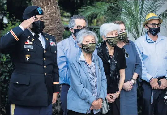  ?? SARAH REINGEWIRT­Z — STAFF PHOTOGRAPH­ER ?? Sisters Leontine Rose and Roberta Finkle watch the casket of their cousin, 1st Lt. Ernest L. Roth, a pilot from Van Nuys who was killed over Germany in World War II, arrive at Pierce Brothers Mortuary in Westwood Village on Wednesday.