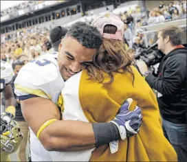  ?? DAVID GOLDMAN / AP ?? Linebacker Tre’ Jackson and now-fiancee Desi Nathe celebrate after he presented her with a 1.35-carat diamond ring and asked for her hand in marriage.