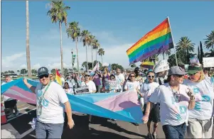  ?? AP PHOTO ?? People march in the gay pride parade in St. Petersburg, Fla.