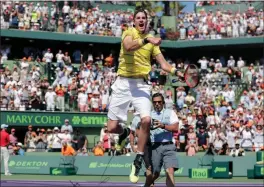  ?? Lynne Sladky / AP ?? John Isner celebrates after defeating Alexander Zverev during the final at the Miami Open on Sunday in Key Biscayne, Fla. Isner won 6-7 (4), 6-4, 6-4.