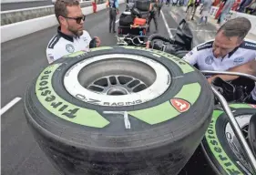  ?? DARRON CUMMINGS/AP ?? Tires made from natural rubber derived from a desert shrub sit on a cart before the pit stop contest ahead of the Indianapol­is 500 on May 27 in Indianapol­is.