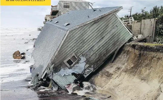  ?? GARY LLOYD MCCULLOUGH / THE FLORIDA TIMES-UNION VIA THE ASSOCIATED PRESS ?? The wreckage of a house sits half in the Atlantic Ocean on Monday in the aftermath of Hurricane Irma in Ponte Vedra Beach near Jacksonvil­le in northern Florida.