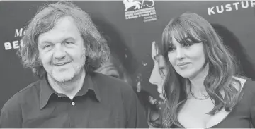  ??  ?? Bellucci poses with director Kusturica during a photocall of the movie ‘Milky Road’, on Monday in Rome. (Left) Bellucci poses during the French premiere of ‘Spectre’ on Oct 29, 2015 in Paris. — AFP photos