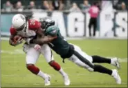  ?? MATT ROURKE — THE ASSOCIATED PRESS ?? The Philadelph­ia Eagles’ Nigel Bradham, right, brings down Arizona Cardinals running back Andre Ellington during a game earlier this season.