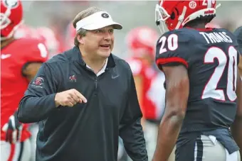  ?? AP PHOTO/BRETT DAVIS ?? Georgia football coach Kirby Smart talks to defensive back JaCorey Thomas before the G-Day spring game on April 16 at Sanford Stadium in Athens.