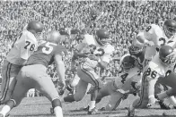  ?? ?? University of Southern California runningbac­k O.J. Simpson (32) runs Oct. 14, 1967, against Notre Dame in the first half of an NCAA college football game in South Bend, Ind. Blocking for USC are Bob Miller (86), Mike Taylor (74), and Dan Scott (38). O.J. Simpson, the decorated football superstar and Hollywood actor who was acquitted of charges he killed his former wife and her friend but was found liable in a separate civil trial, has died. He was 76. The family announced on Simpson’s official X account that he died Wednesday of prostate cancer.(ap Photo/file)