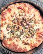  ?? TOM MCCORKLE For The Washington Post ?? Italian Sausage and Kalamata Olive Skillet Pizza