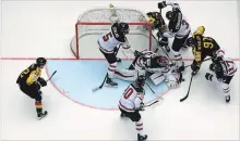  ?? MARTIN ROSE GETTY IMAGES ?? Canadian goalie Darcy Kuemper is surrounded against Germany in a world hockey championsh­ip contest in Denmark.