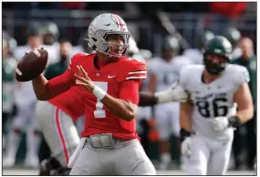  ?? (AP/Jay LaPrete) ?? Ohio State quarterbac­k C.J. Stroud threw six touchdown passes in the first half Saturday — tying a school record — to lead the No. 4 Buckeyes to a 56-7 victory over No. 7 Michigan State in Columbus, Ohio.