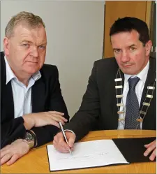  ??  ?? County Council Chairman, John Hegarty (right), and Pat Collins, County Secretary, open the book of condolence to remember victims of the Las Vegas tragedy at County Buildings.