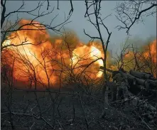  ?? LIBKOS VIA THE ASSOCIATED PRESS ?? Ukrainian soldiers fire an artillery at Russian positions near Bakhmut, Donetsk region, Ukraine on Sunday.