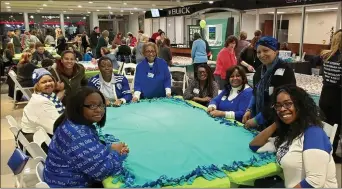  ?? PHOTO COURTESY MELISSA DODORO, CATHY WARREN ?? Volunteers make comfort blankets for grieving families at a past event at Art Moran Buick GMC in Southfield.