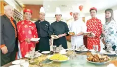  ??  ?? Vietnam’s award-winning internatio­nal chefs Chef Thanh Long (third right) and Chef Vinh Co (fourth right), flanked by Dorset Grand Hotel general manager Susan Carlos (right), hotel manager Abd Rahman S. Ahmad (left) and hotel staff during their first...