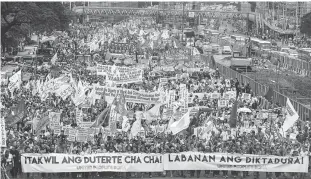  ??  ?? STREET OF PROTEST – Several militant groups brought their protest against the Duterte administra­tion to Commonweal­th Avenue leading to the Batasan Pambansa where the President delivered his third State of the Nation Address (SONA) yesterday afternoon....