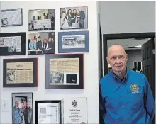  ?? DAVE JOHNSON
THE WELLAND TRIBUNE ?? Frank Adamson stands beside a wall with some of his achievemen­ts inside his business, KwikFit Niagara.