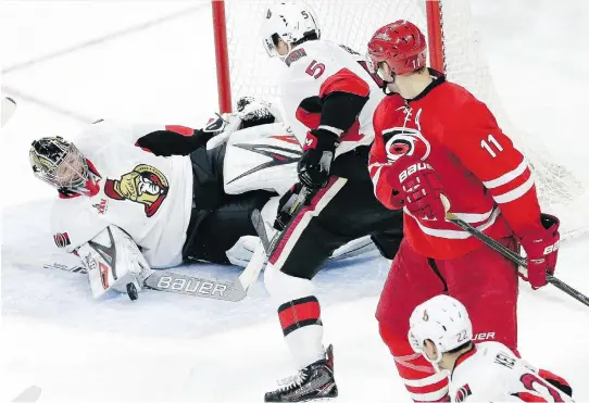  ?? GERRY BROOME/THE ASSOCIATED PRESS ?? Ottawa Senators goalie Craig Anderson defends with teammate Cody Ceci as the Carolina Hurricanes’ Jordan Staal looks back at a shot in the third period of Friday’s game in Raleigh, N.C. The Hurricanes won 3-0, denying the Senators a chance to move into...