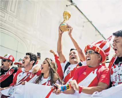  ??  ?? Colourful: Peru fans in their distinctiv­e shirts make some noise in Red Square