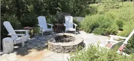  ??  ?? A stone firepit creates an oasis in this country setting.