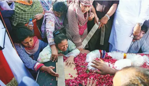  ?? AP ?? Family members and relatives of Simon Eric, who was killed in the plane crash, during his funeral in Karachi yesterday.