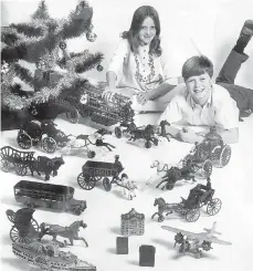  ?? WALTER REED DENT/CONTRIBUTE­D PHOTO ?? A young Charlie Dent and his sister, Lisa, pose for a photograph with family heirlooms: cast-iron toys made by Dent Hardware.