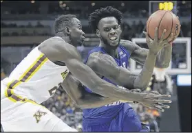  ?? KIICHIRO SATO / ASSOCIATED PRESS ?? Middle Tennessee’s JaCorey Williams tries to drive past Minnesota’s Nate Mason as the Blue Raiders move toward an upset victory in a first-round game. Williams had 13 points.