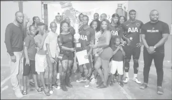  ??  ?? TWICE IS NICE! Adrian Aaron of Bent Street collecting the championsh­ip trophy during the official presentati­on ceremony after defeating Rio All-Stars in the finale of the Magnum Mash Cup Futsal Championsh­ip at the National Gymnasium, Mandela Avenue.